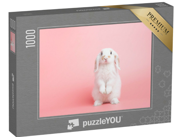 Puzzle de 1000 pièces « Un lapin blanc aux oreilles pendantes pose sur un fond rose »